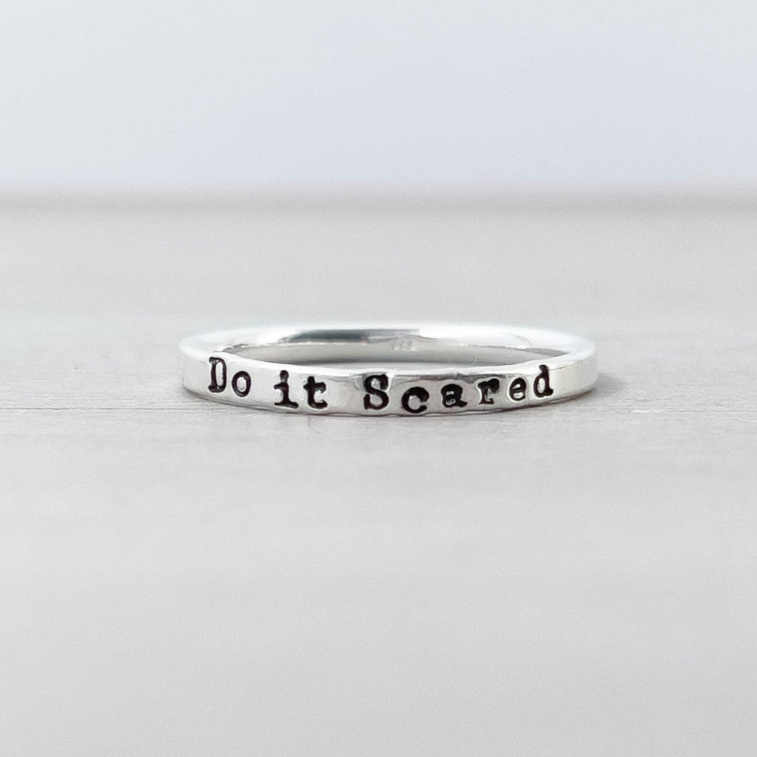 image of sterling silver affirmation ring stamped with Do it Scared on it
