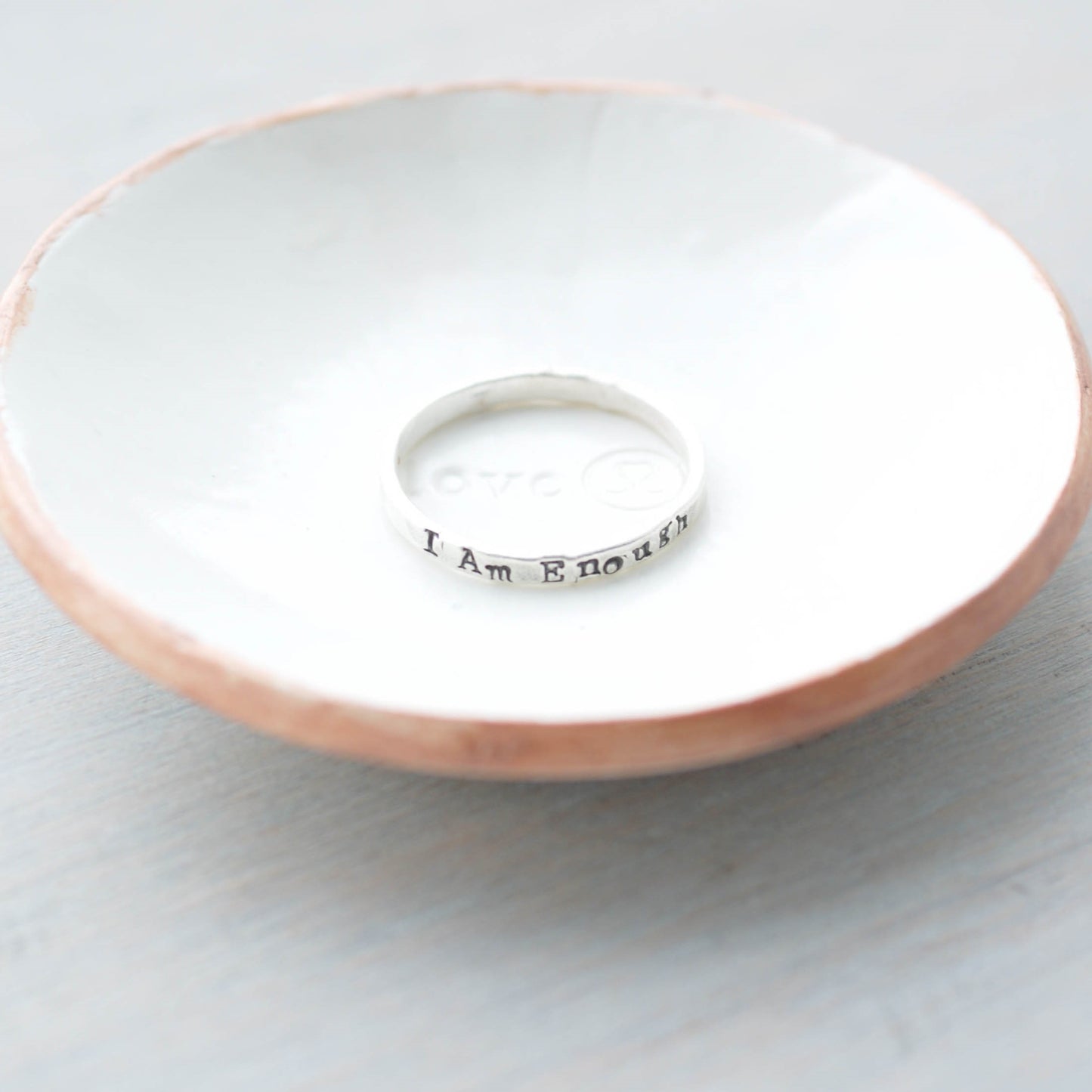I am enough sterling silver ring in a ring dish