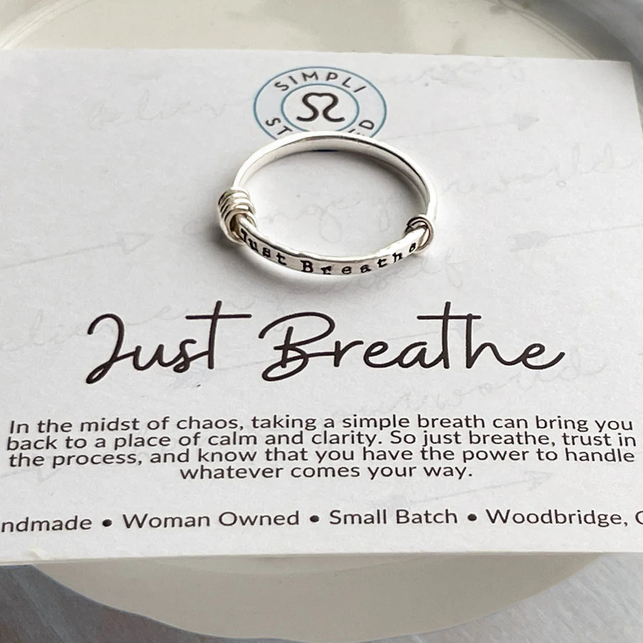 image of sterling silver ring stamped with Just Breathe on an inspirational card
