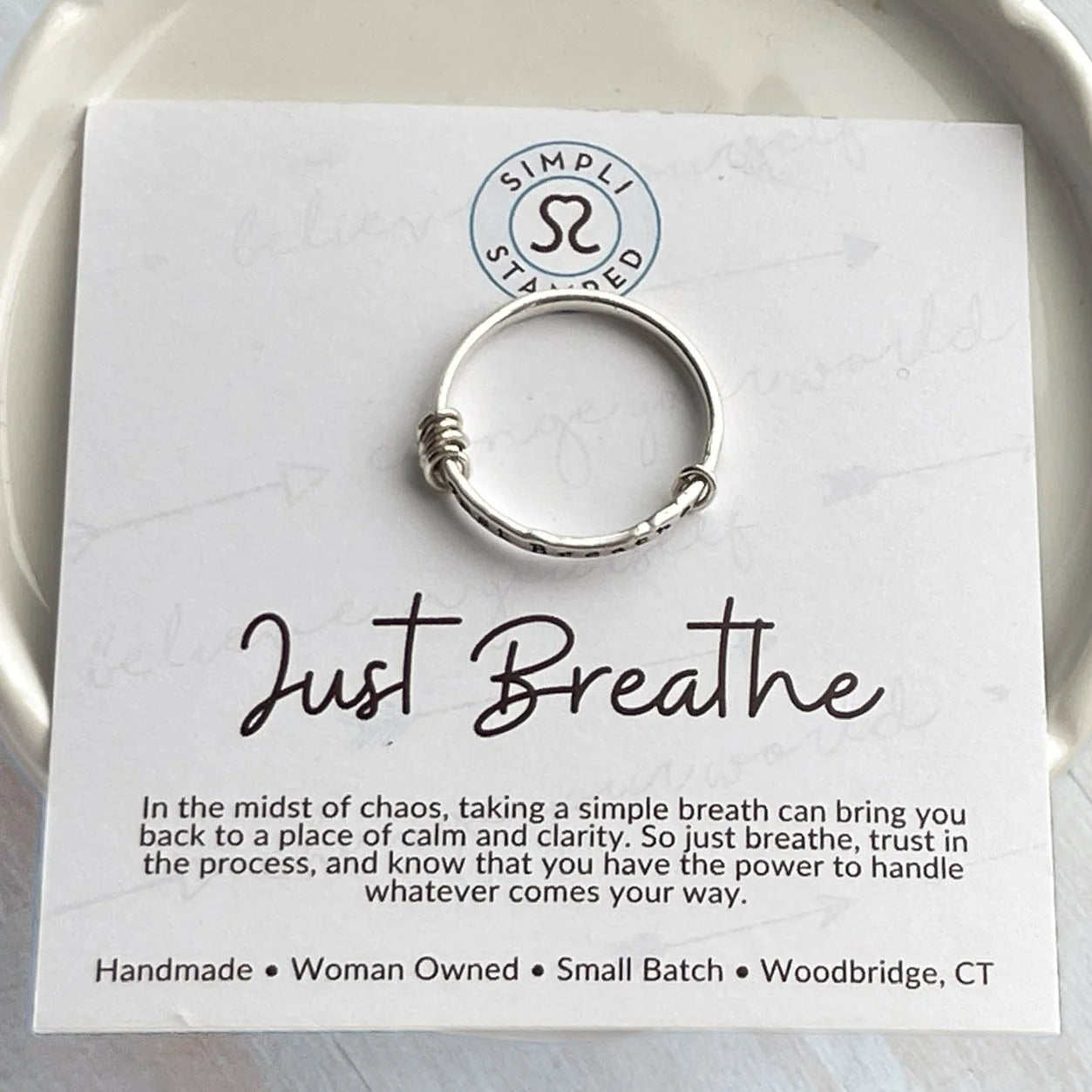 image of sterling silver ring stamped with Just Breathe on an inspirational card