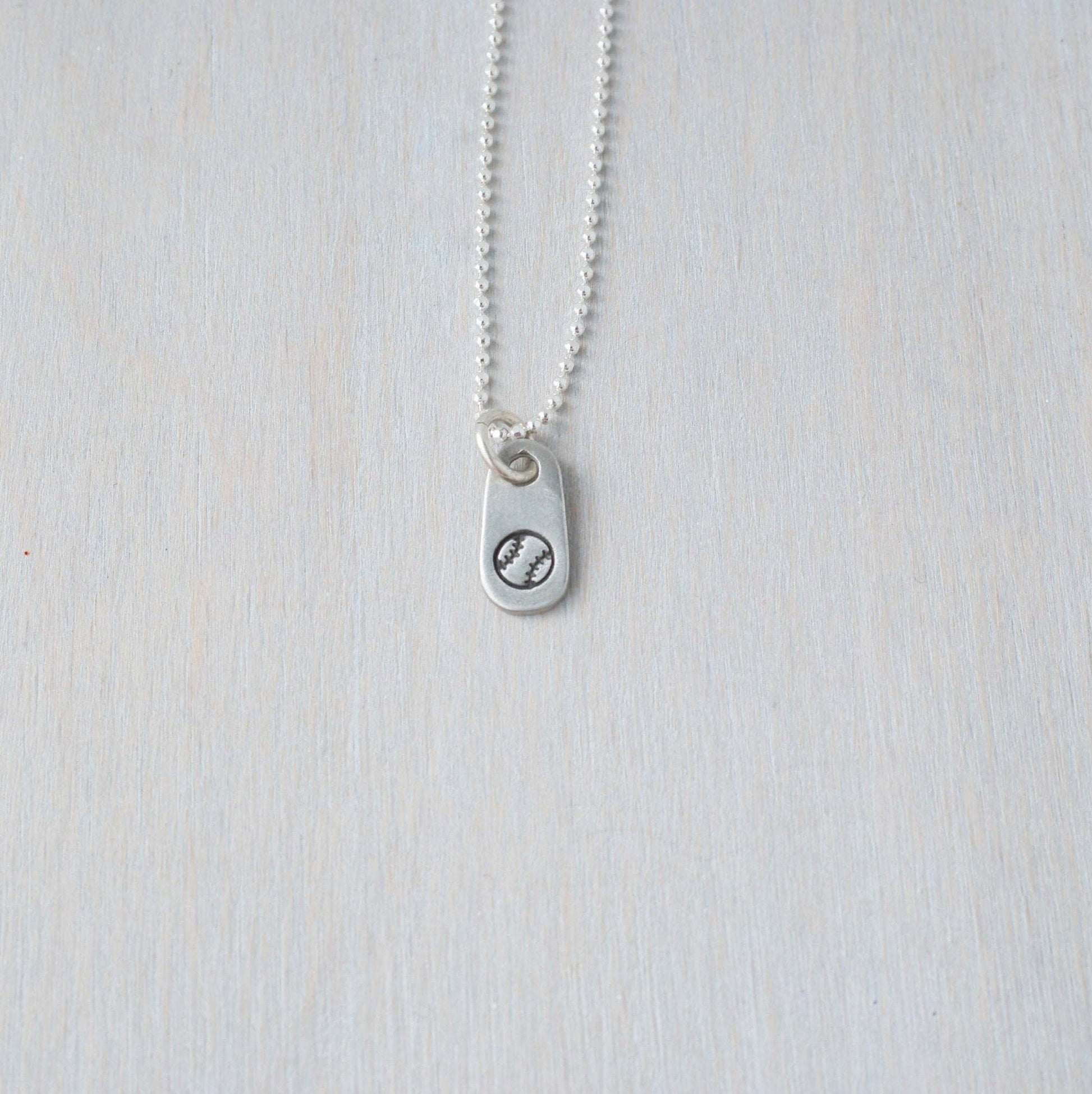 Silver softball necklace in artisan pewter