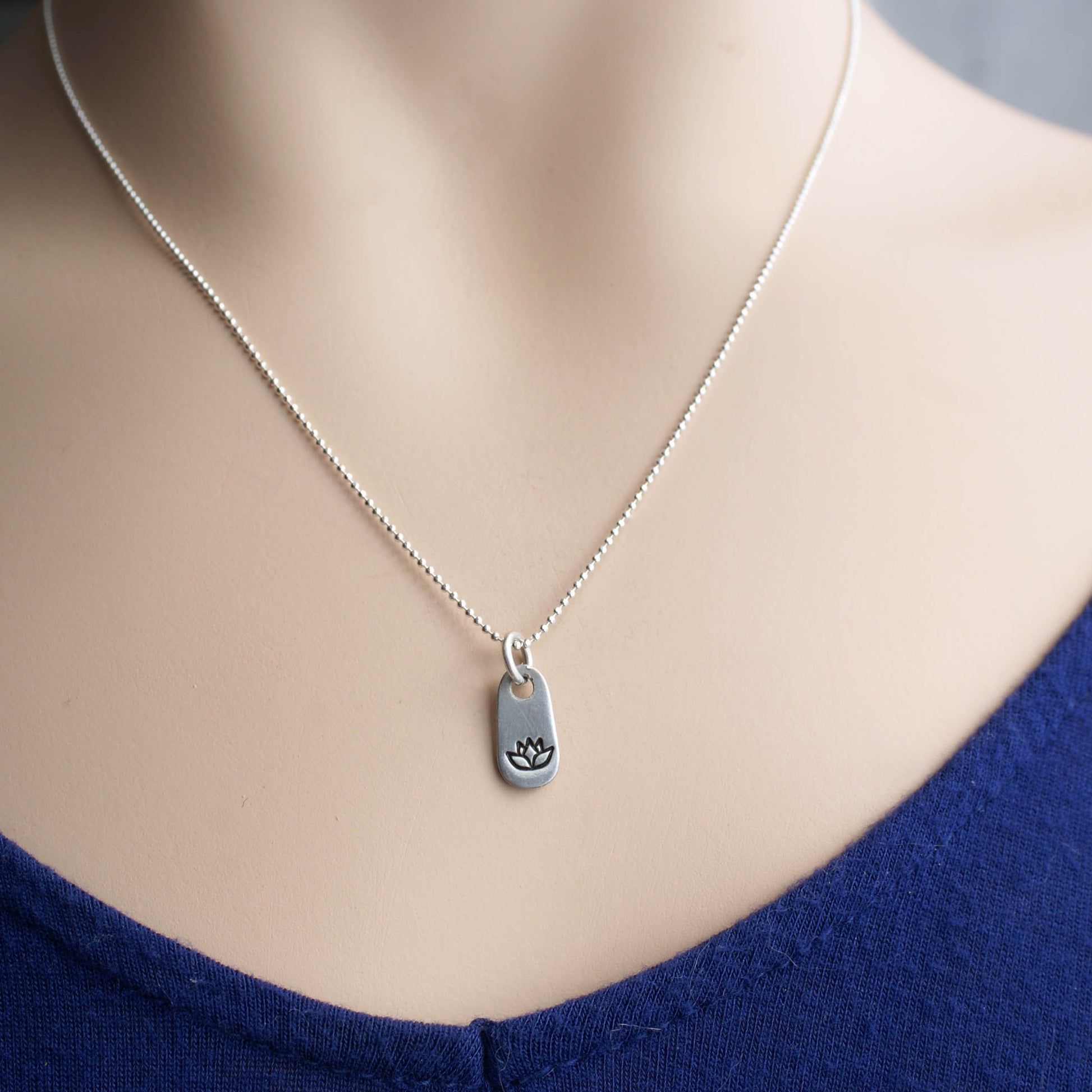 Silver lotus necklace in artisan pewter on neck