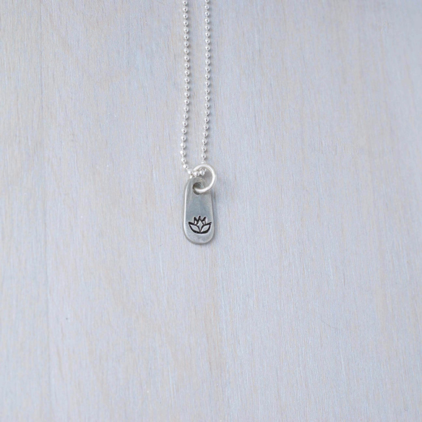 Silver lotus necklace in artisan pewter