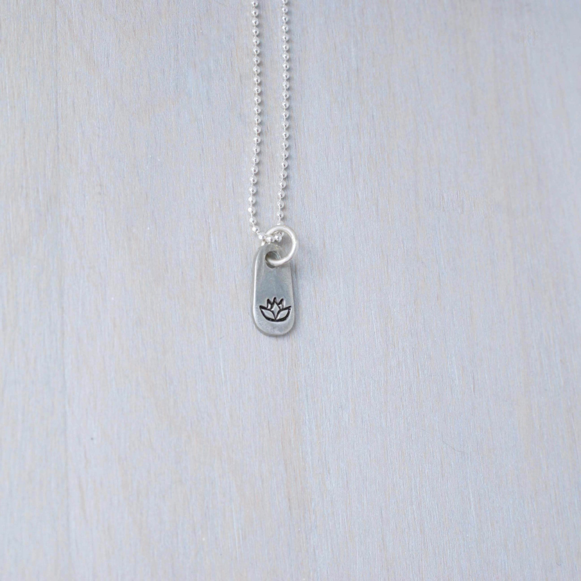 Silver lotus necklace in artisan pewter
