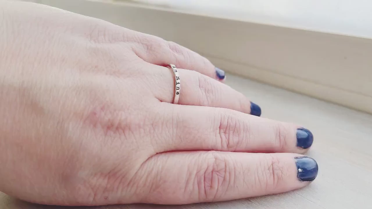 Sterling Silver Stacking Ring handstamped with I Am Mine on hand and being held in hand