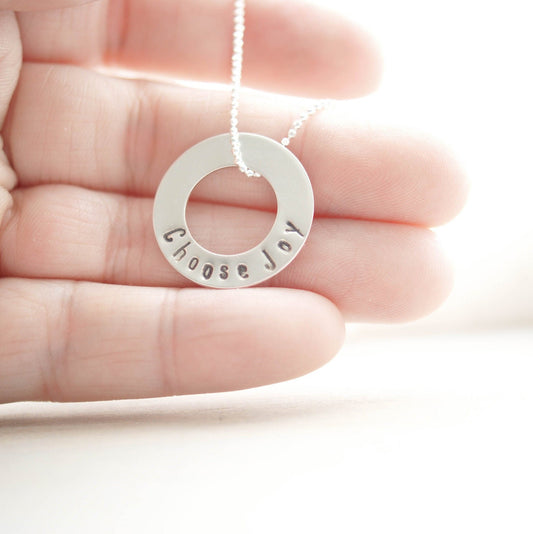 Choose Joy Circle Necklace in Sterling Silver in hand