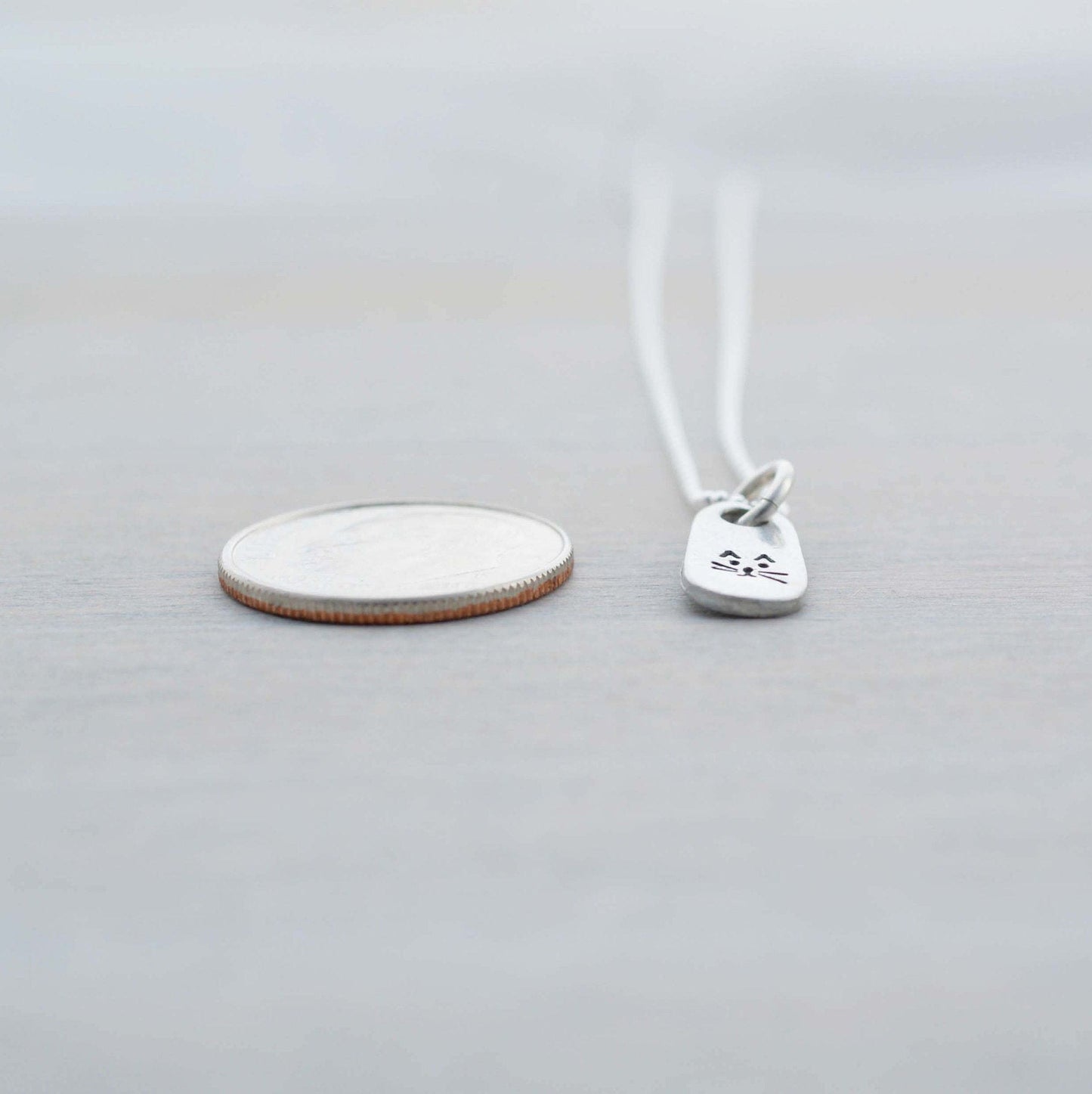 Petite Silver Necklace in Artisan Pewter with handstamped kitty face next to dime
