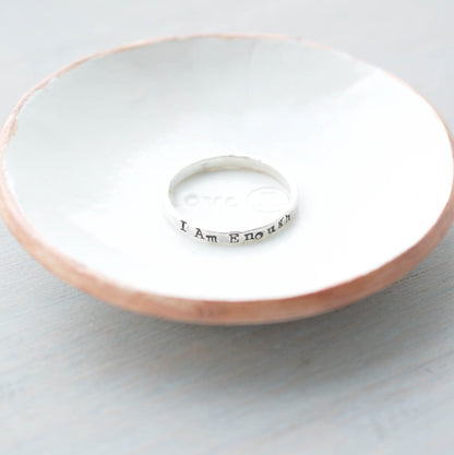 Sterling Silver stacking ring handstmaped with I Am Enough in ring dish