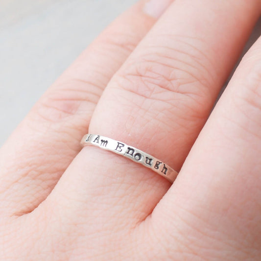 Sterling Silver stacking ring handstmaped with I Am Enough on hand