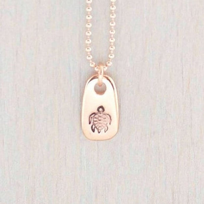 Rose gold necklace stamped with a turtle