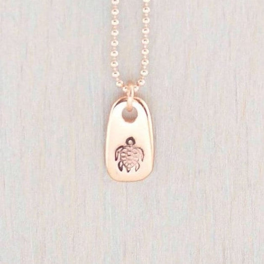 Rose gold necklace stamped with a turtle