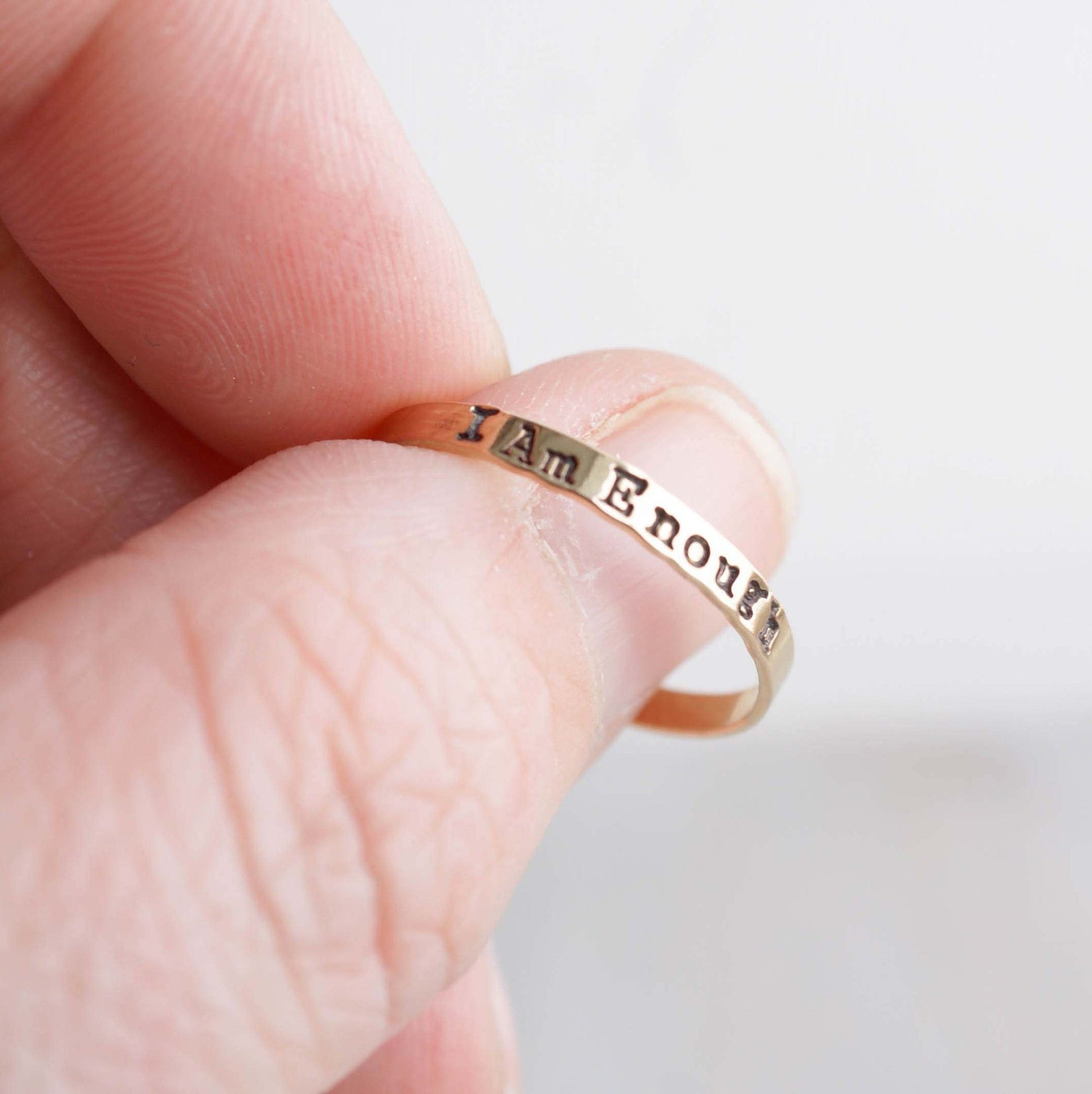 I am Enough ring handstamped in gold-filled on thumb