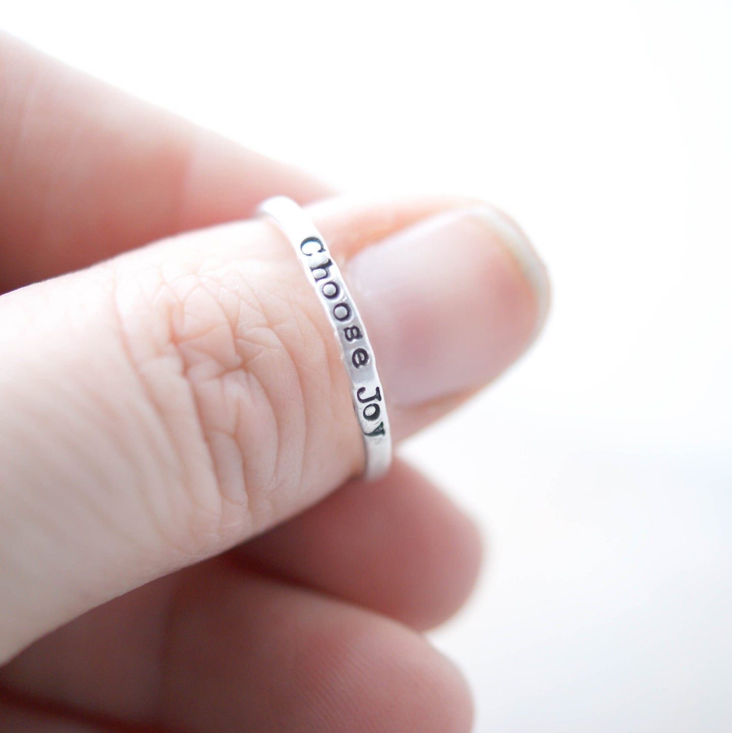 Stacking ring in Sterling silver handstamped with Choose Joy on thumb