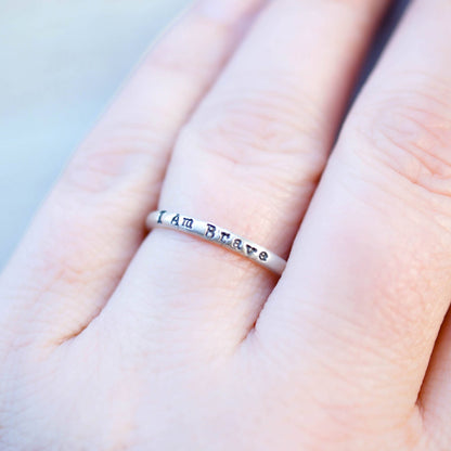 Sterling Silver ring stamped with I Am Brave on hand