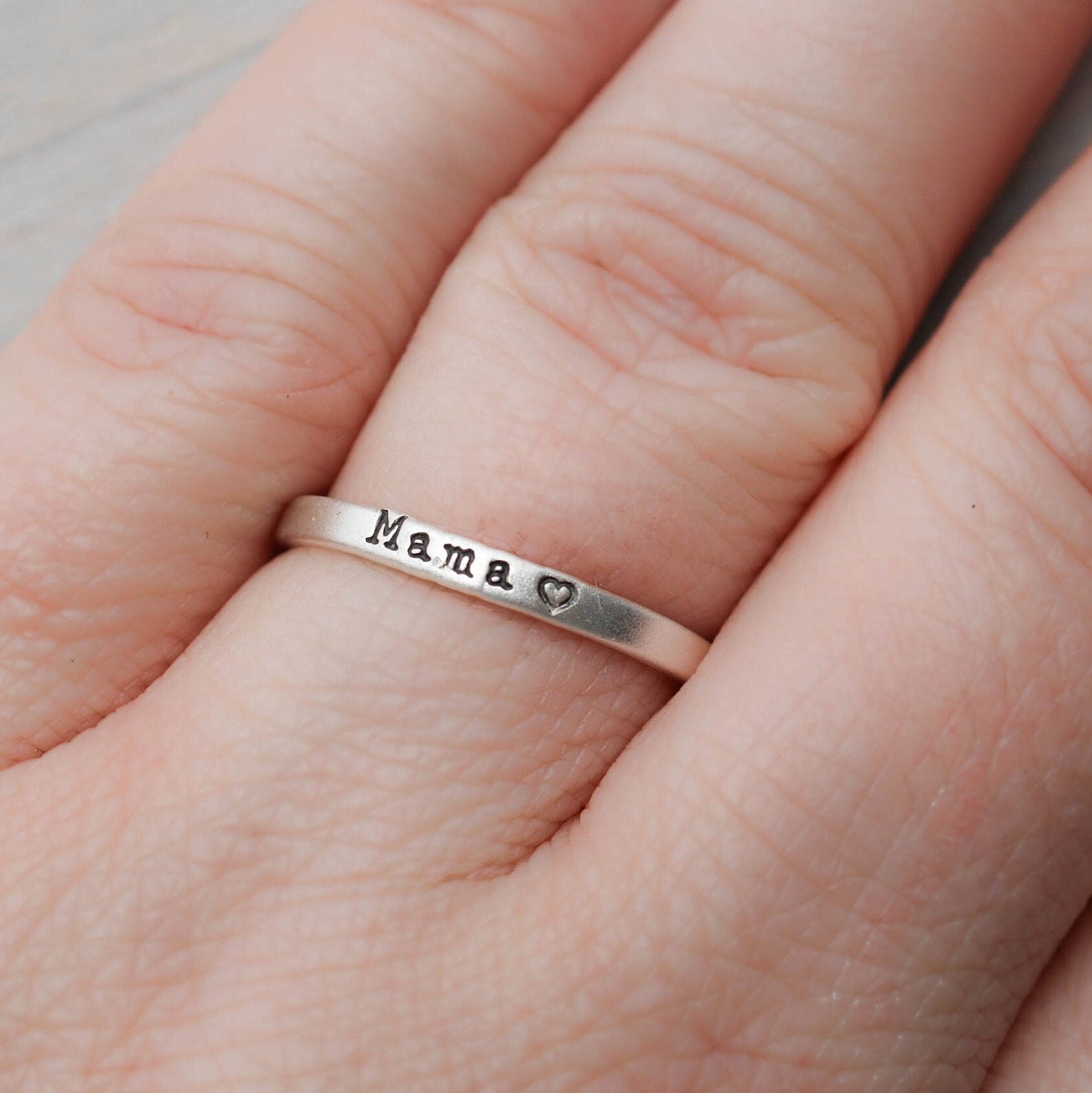 Sterling silver ring handstamped with Mama and one heart on hand
