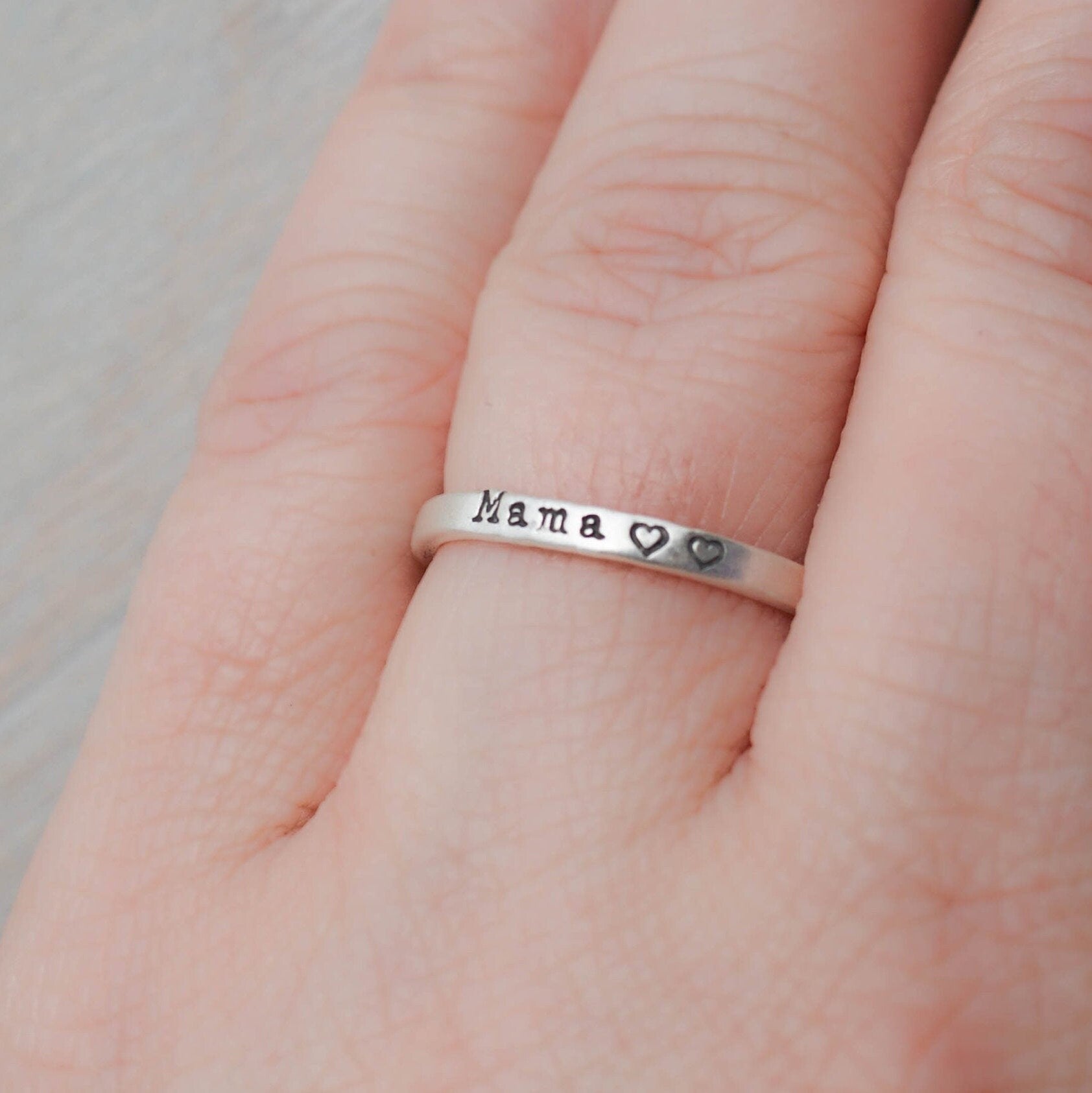 Sterling silver ring handstamped with Mama and two hearts on hand