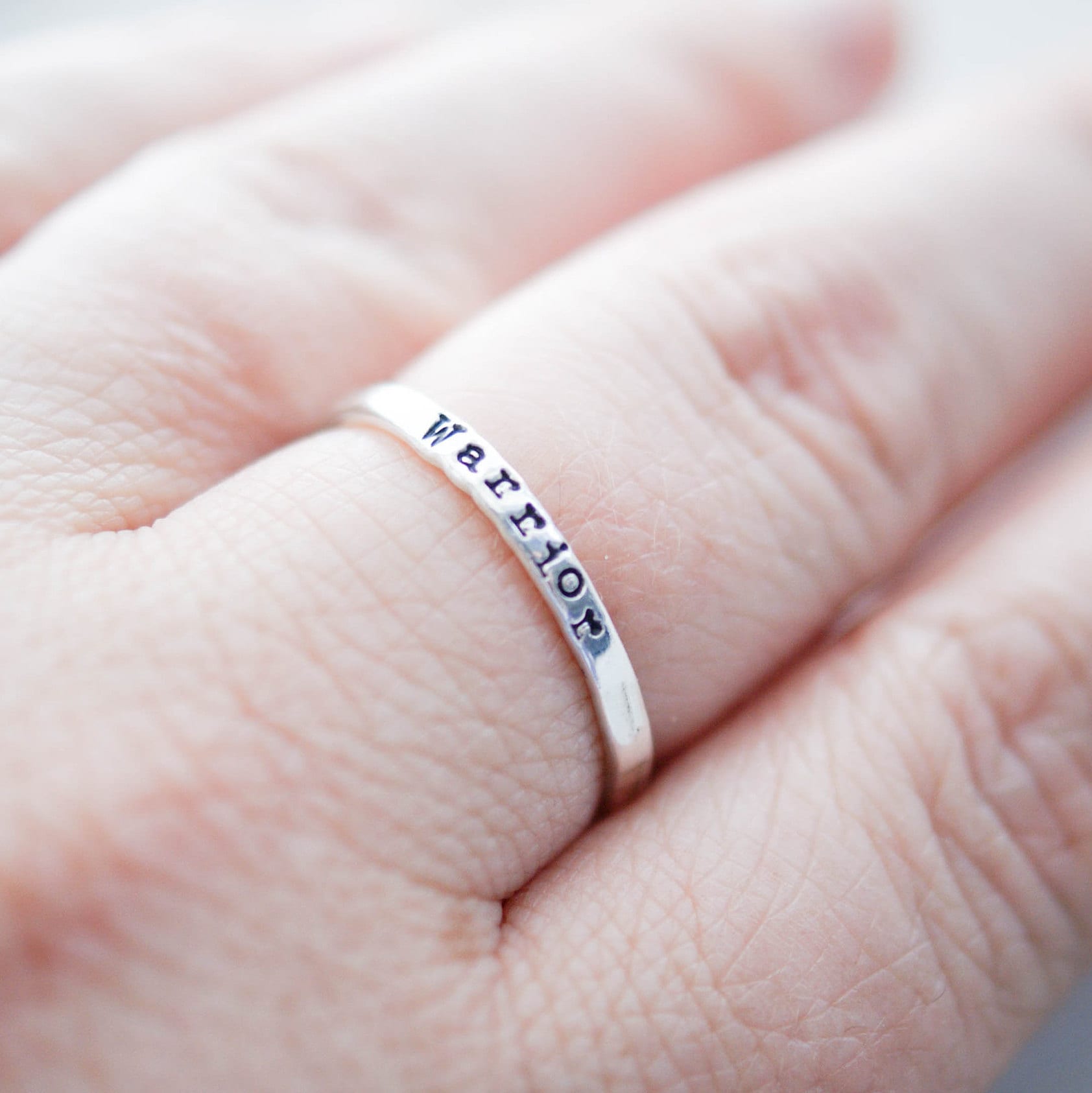 Sterling silver ring stamped with Warrior on hand