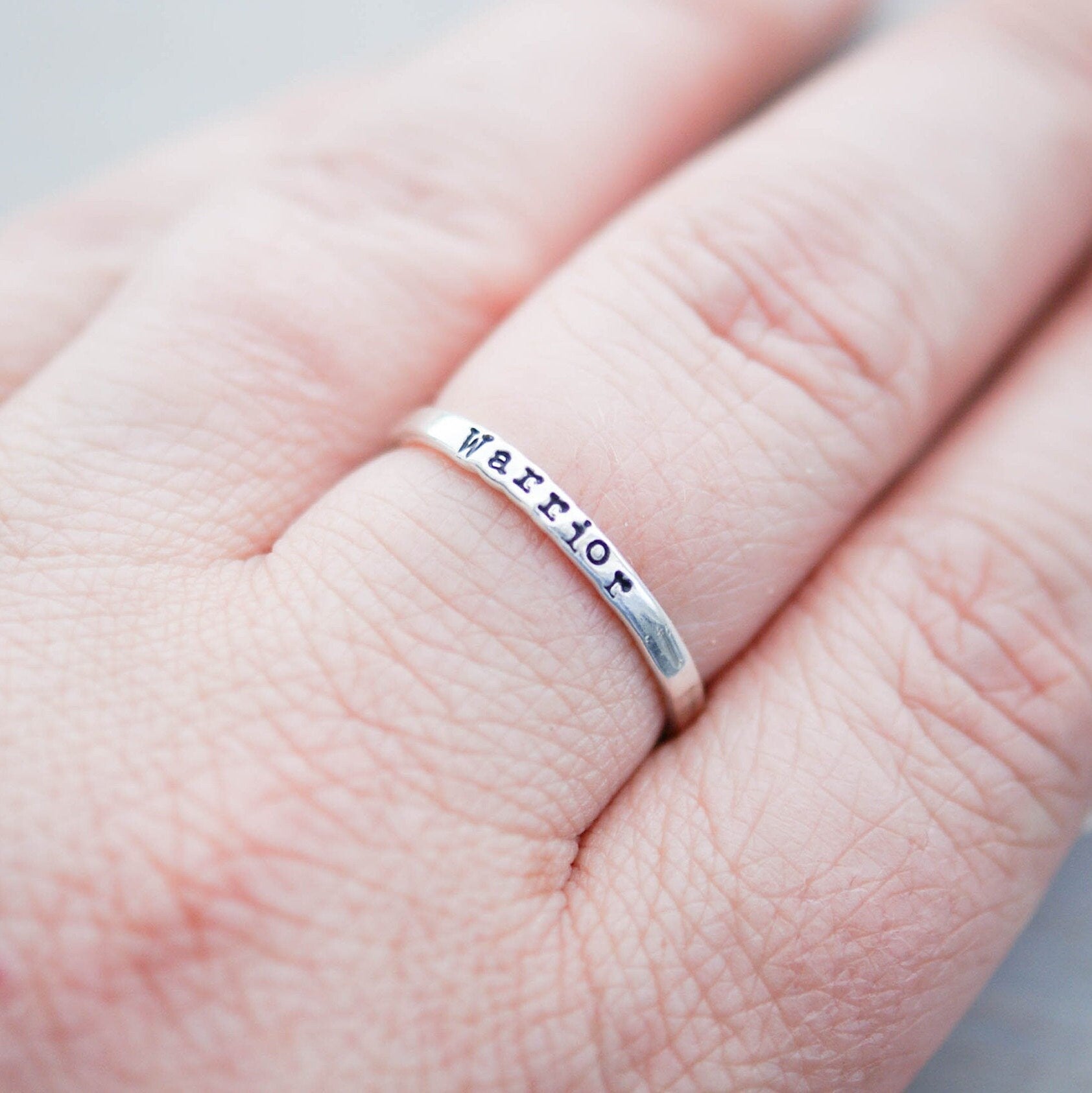 Sterling silver ring stamped with Warrior on hand