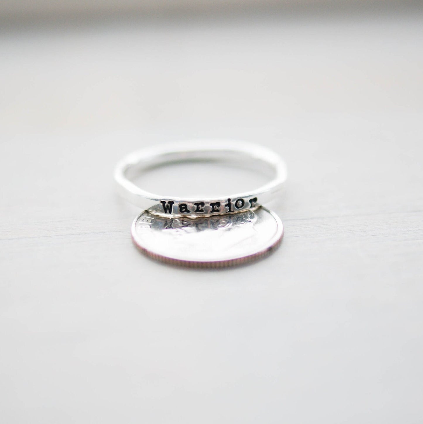 Sterling silver ring stamped with Warrior on dime