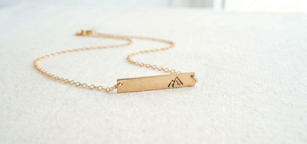 Everyday inspirational jewelry with gold filled necklaces on a light neutral background.