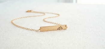 Everyday inspirational jewelry with gold filled necklaces on a light neutral background.