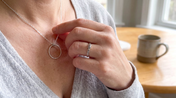 sterling silver fidget necklace and ring being worn