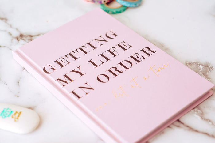 image of a pink book for setting intentions for the new year titled  