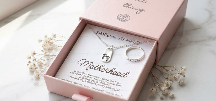Motherhood sterling silver necklace and ring set in a pink box with 'Simpli Stamped' branding.