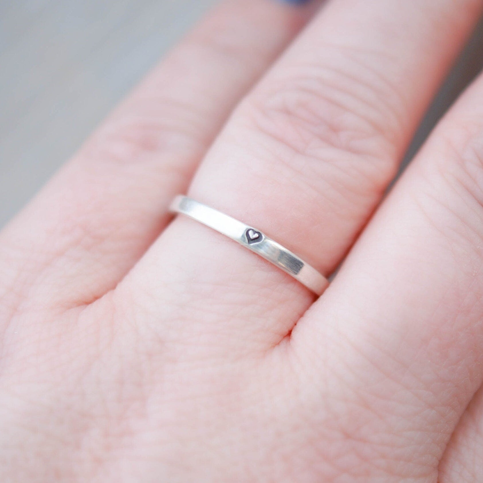 Sterling silver ring stamped with small heart on hand