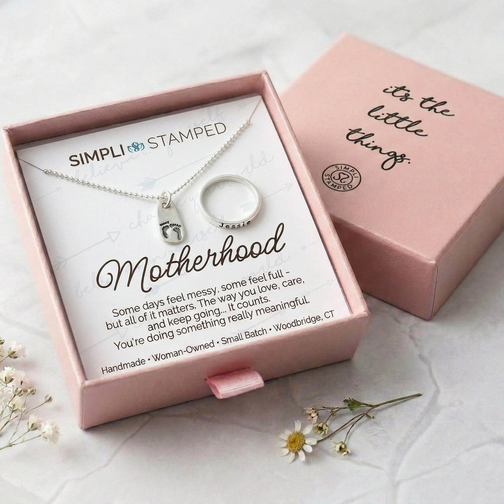 Motherhood necklace and ring set in a pink box with 'Simpli Stamped' branding.