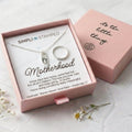 Motherhood necklace and ring set in a pink box with 'Simpli Stamped' branding.