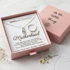 Motherhood necklace and ring set in a pink box with 'Simpli Stamped' branding.