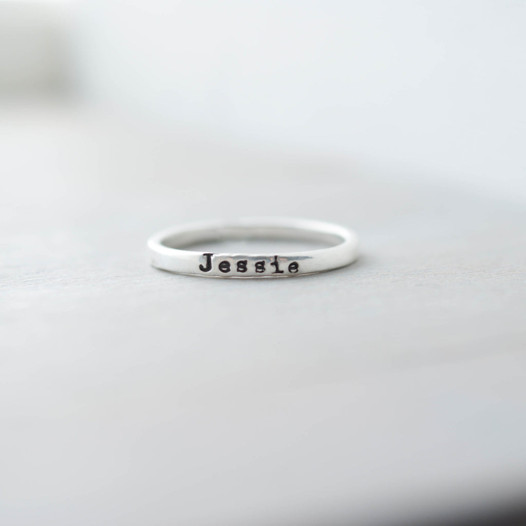 Sterling silver ring with 'Jessie' stamped on a light gray background