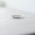 Sterling silver ring with 'Jessie' stamped on a light gray background
