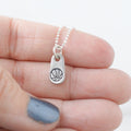 Silver mom jewelry basketball necklace in artisan pewter in hand