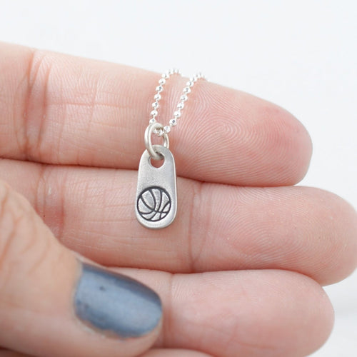 Silver mom jewelry basketball necklace in artisan pewter in hand