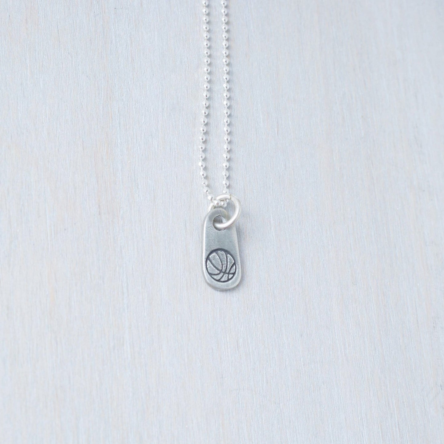 Silver basketball necklace for athlete in artisan pewter