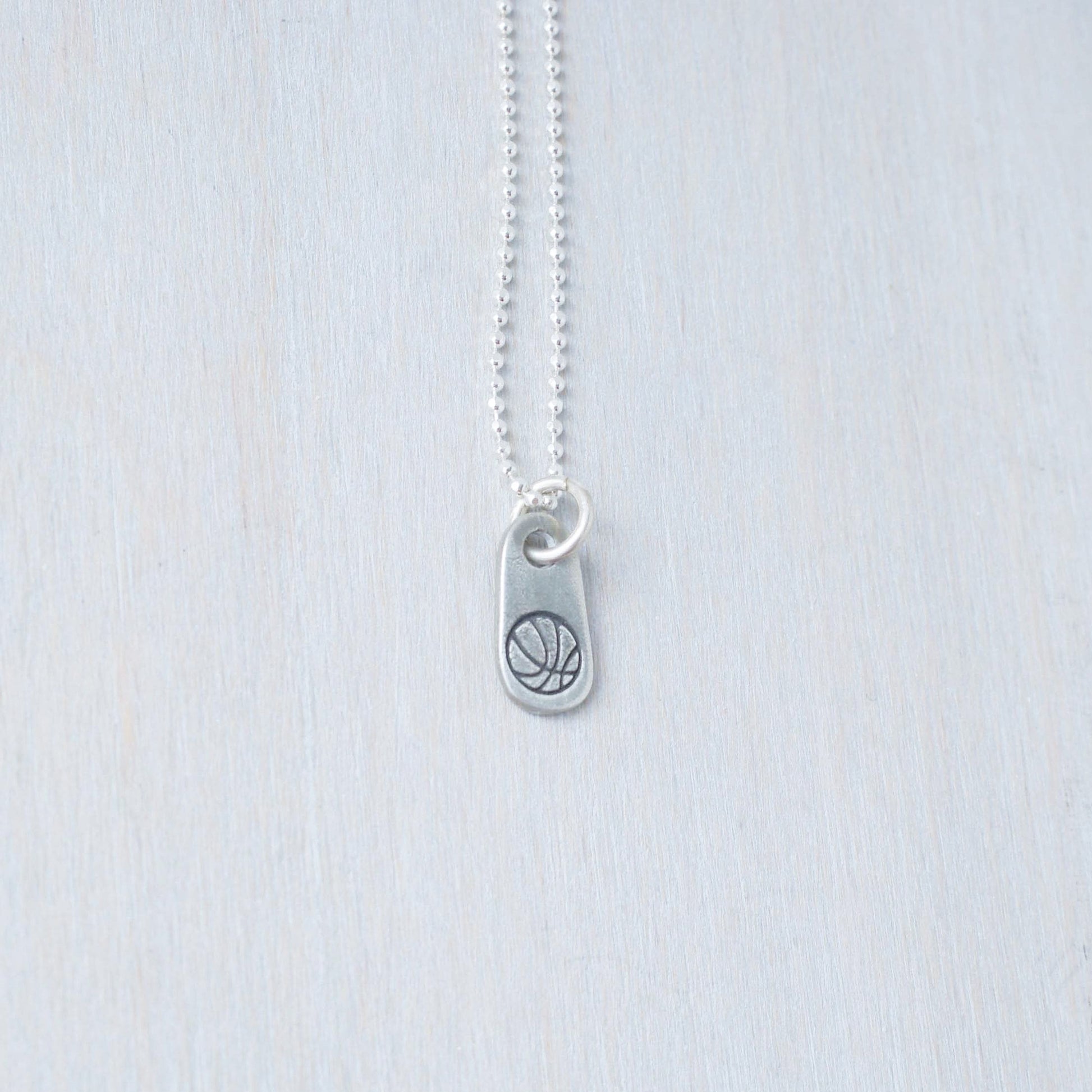 Silver basketball necklace for athlete in artisan pewter