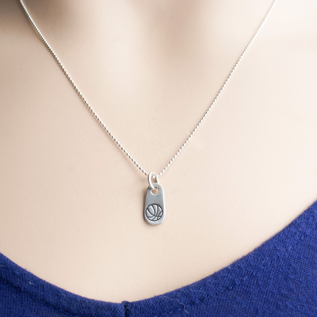 Silver basketball necklace for mom in artisan pewter on neck