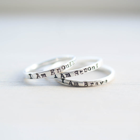 Three rings stacked, stamped with I Am Enough, I Am Strong, I Am Brave