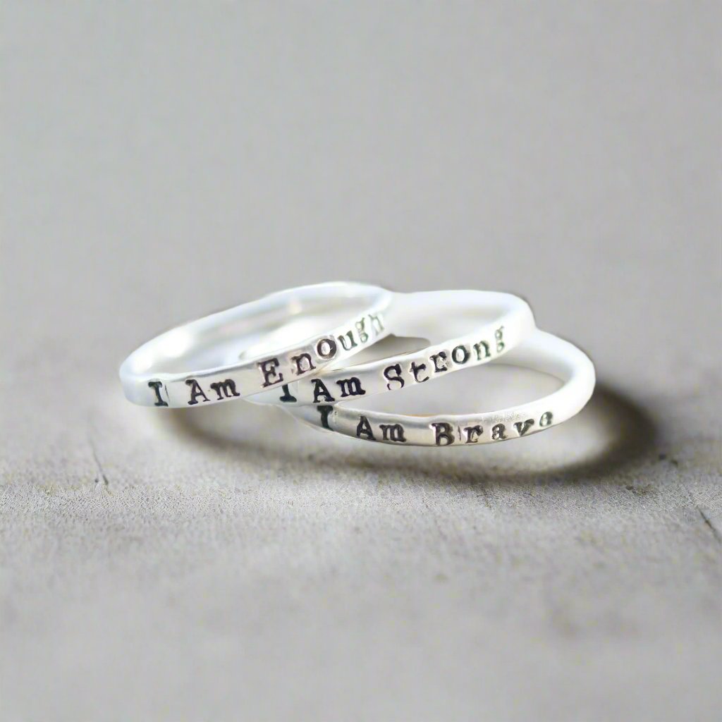 Three rings stacked, stamped with I Am Enough, I Am Strong, I Am Brave