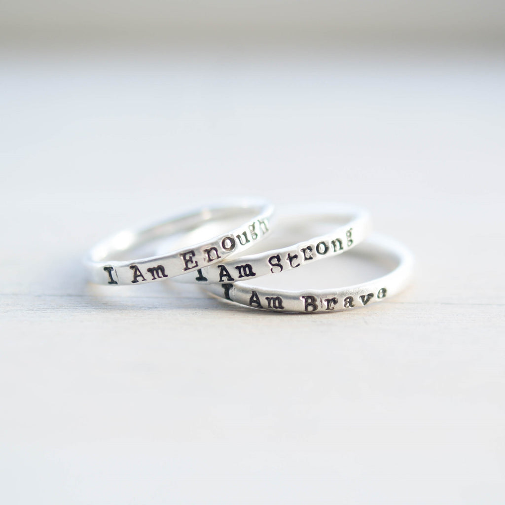 image of 3 sterling silver rings stamped with i am strong, i am brave, i am enough