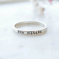 Silver ring with 'You Matter' stamped on a white background