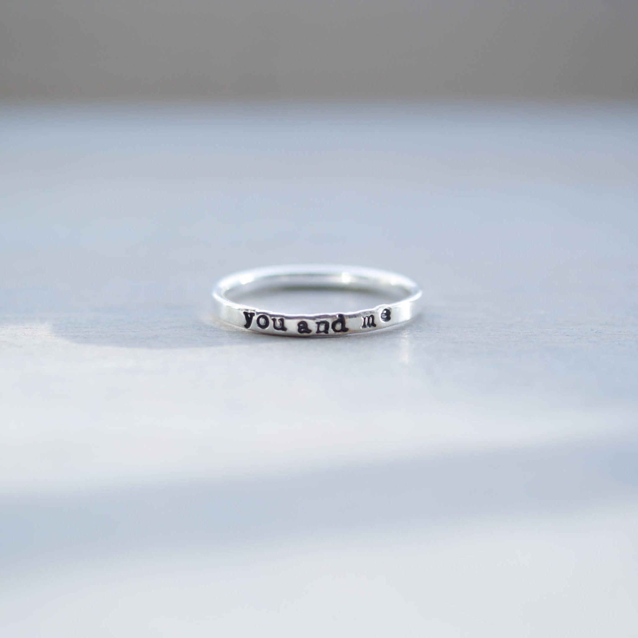 Skinny sterling silver ring stamped with you and me