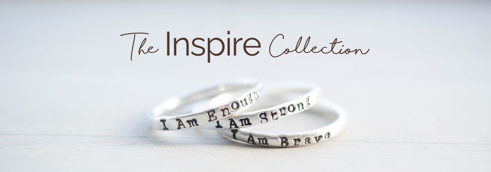 Image of 3 rings stamped with I Am Strong, I Am Brave, I am Enough