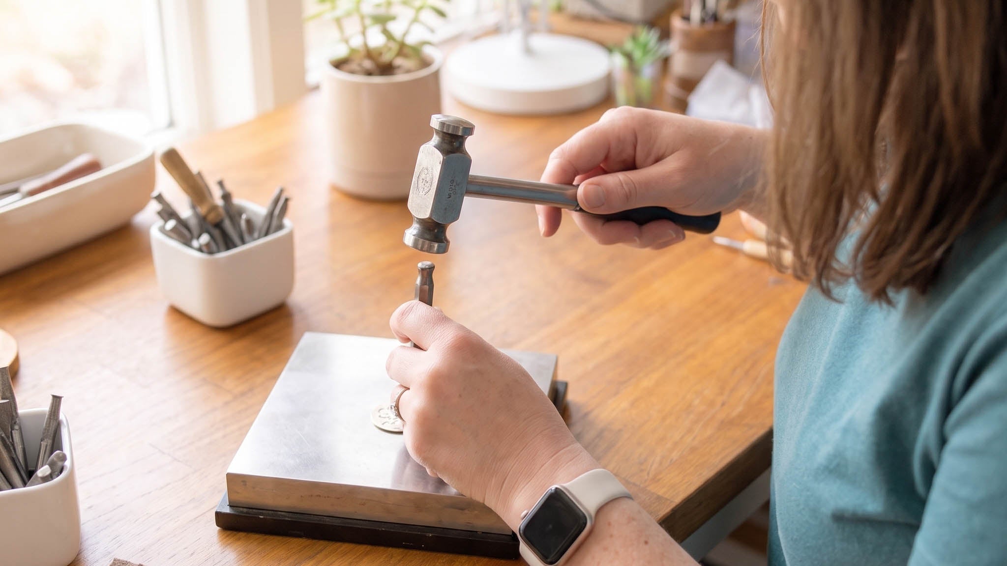 Amber handmaking jewelry at workbench