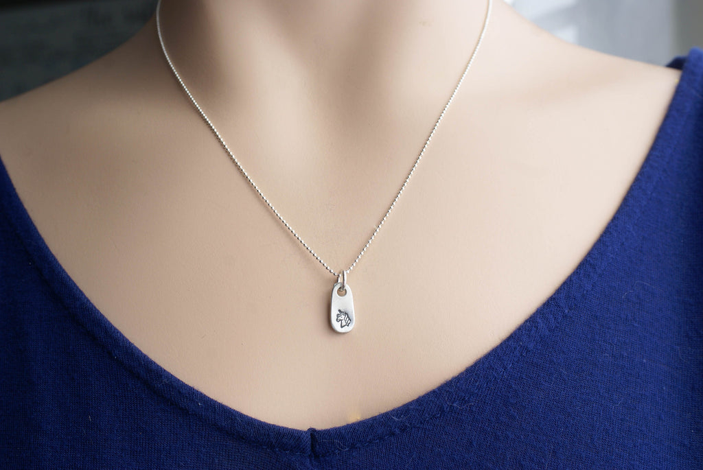 Silver unicorn necklace in artisan pewter on neck