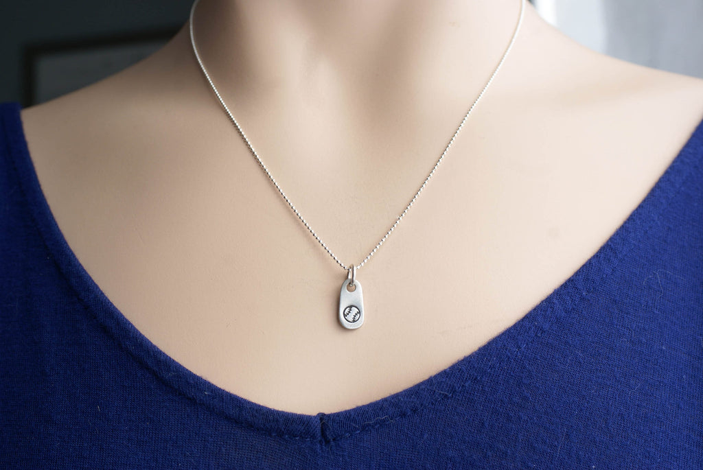 Silver baseball necklace in artisan pewter on neck