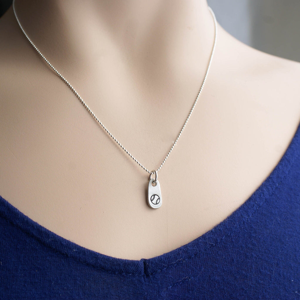 Silver softball necklace in artisan pewter on neck