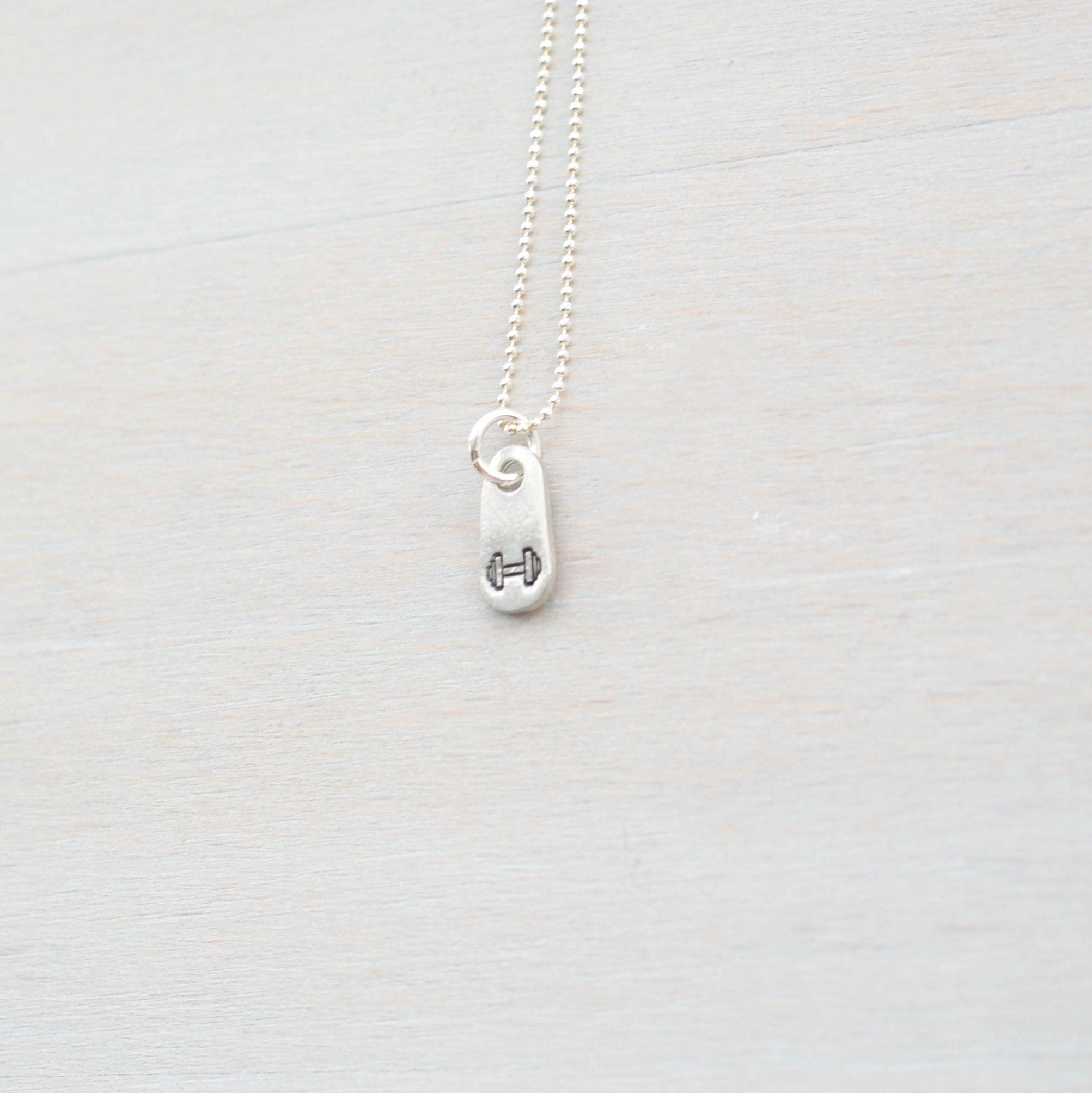 Silver dumbbell necklace for gym lover in artisan pewter